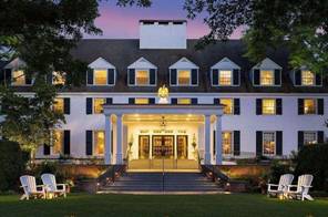 A large white house with a lawn and trees

AI-generated content may be incorrect.